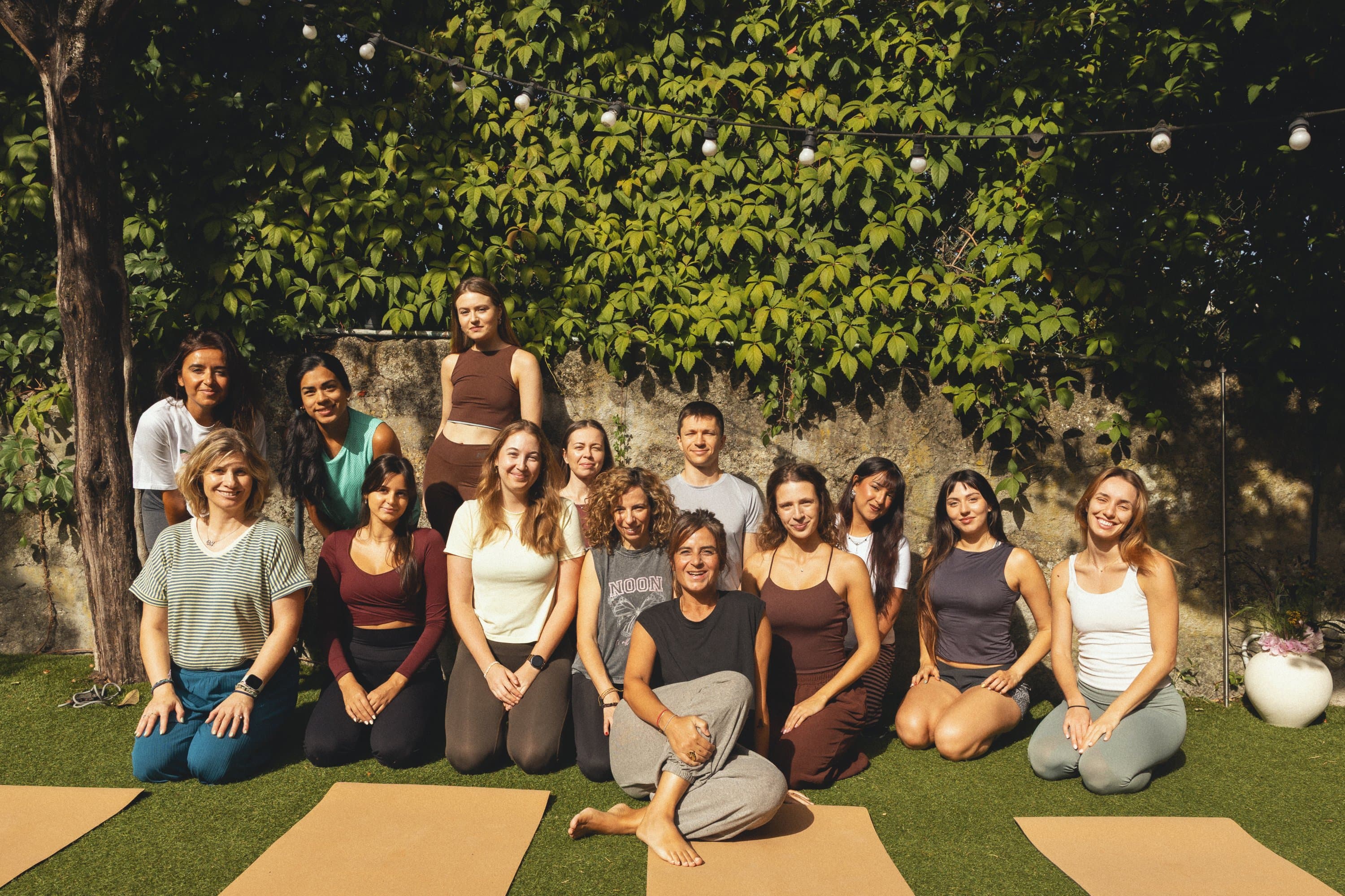 The group sits together on their mats after class.