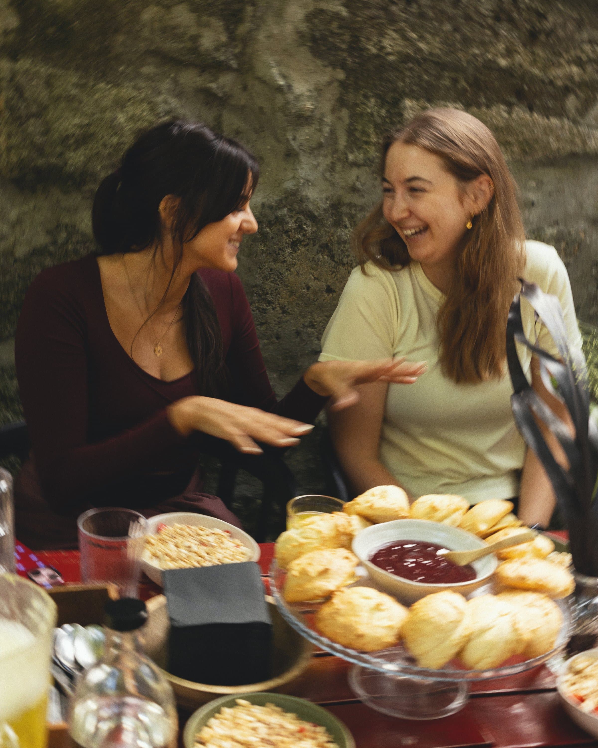 Two participants laugh over brunch.